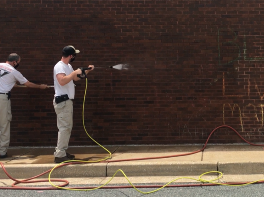 Power washing chalk graffiti made by elementary school children in Maryand